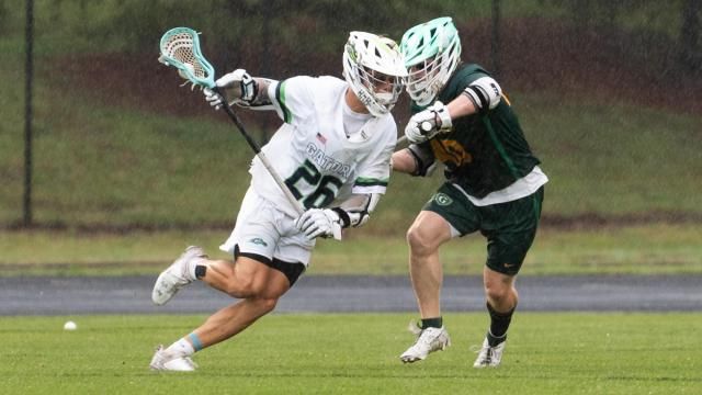 Kelan Moore (26) of Green Level and Joey Jonske (40) of Cardinal Gibbons. For the first time in program history, Green Level is going to play for a boys lacrosse state championship after beating Cardinal Gibbons 16-9 in the NCHSAA 4A eastern regional championship on Tuesday, May 14, 2024. (Photo By: Nick Stevens/HighSchoolOT)